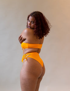 orange bikini bottom with cut outs on the side